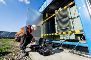 Technician inspecting renewable energy equipment for thermal management applications