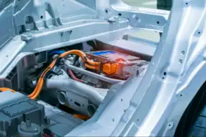 Electric vehicle battery compartment showing thermal management components and cooling connections